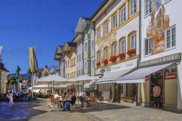 Historic market street with street cafe and typical gabled houses, Bad Tölz. Isartal, Upper Bavaria, Bavaria, Germany
