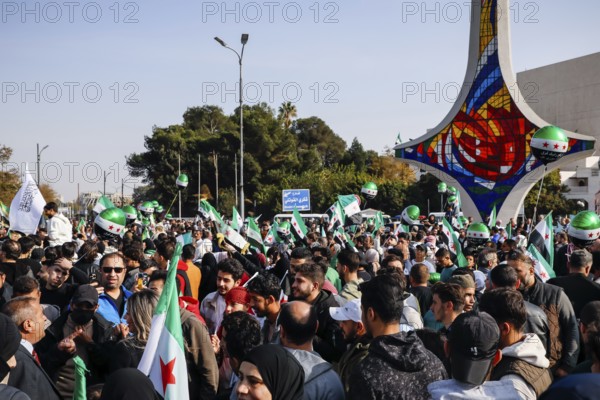 Damascus, Syria. November 28, 2025: Thousands of Syrians gather in Umayyad Square in central Damascus to celebrate the anniversary of the military operation that led to the fall of Bashar al-Assad's regime. Demonstrators express joy and unity while denouncing Israeli attacks on Syrian territory, Damascus, Damascus, Syria