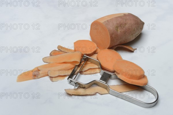 Sweet potatoes with potato peeler, potato slices, partially peeled, Ipomoea batatas