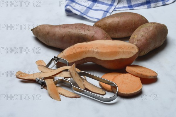 Sweet potatoes with potato peeler, Ipomoea batatas