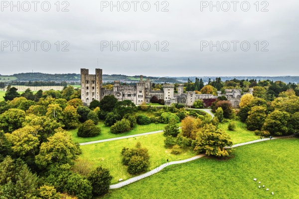 Autumn colours over Penrhyn Castle and Garden from a drone, Llandygai, Bangor, Gwynedd, North Wales, UK