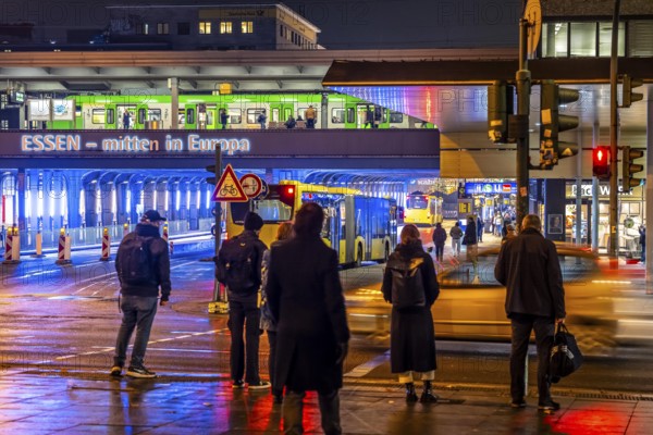 The main train station in Essen, blue illuminated underpass, bus station, am Europaplatz, train on the platform, pedestrian crossing, North Rhine-Westphalia, Germany