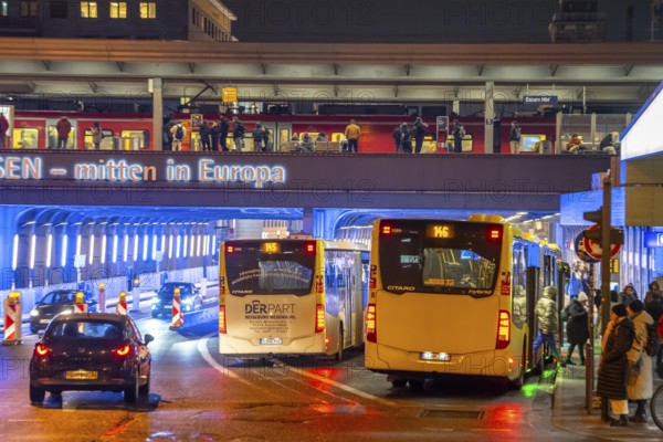 The main train station in Essen, blue illuminated underpass, bus station, am Europaplatz, train on the platform, North Rhine-Westphalia, Germany