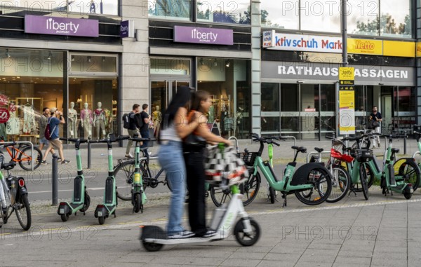 Electric scooters and rental bikes on public roads, Berlin, Germany