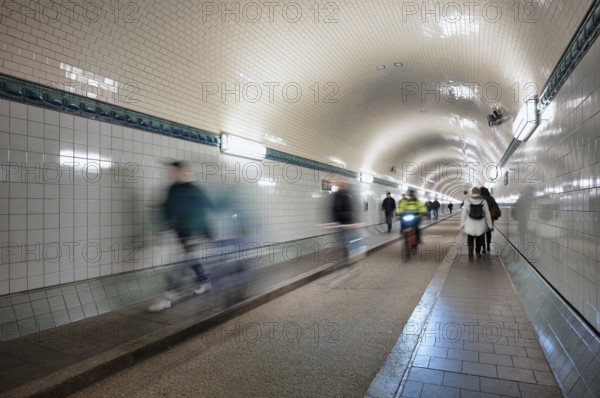 Interior view, pedestrians and cyclists crossing tunnel, mopping effect, movement, tube, historic old Elbe Tunnel, Free and Hanseatic City of Hamburg, Germany