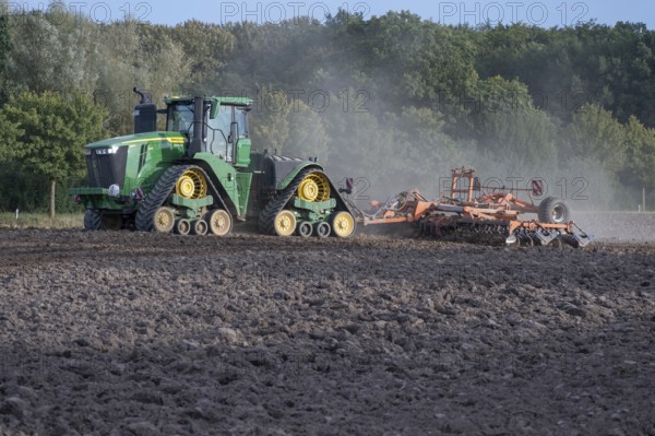 Crawler tractors harrow the field, Othenstorf, Mecklenburg-Western Pomerania, Germany