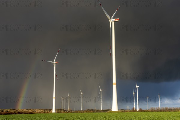 Königshovener Höhe onshore wind farm, on the A44 motorway near Bedburg, in front of the Jackerath triangle, autumn, rainbow, dark rain clouds, recultivated open-cast mining area, Garzweiler open-cast lignite mine, operated by RWE and the city of Bedburg, North Rhine-Westphalia, Germany