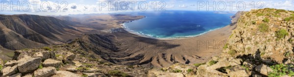 Panorama at Castillejo viewpoint, view from the Risco de Famara cliffs to the coast and the sea with Famara beach, Playa de Famara with La Calaeta, Lanzarote, Canary Islands, Spain