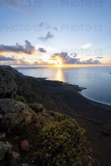 View of steep cliffs on sea and coast, Mirador del Porrito viewpoint at sunset, Lanzarote, Canary Islands, Spain