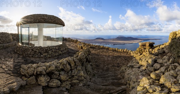 Stairway and viewing platform at the Mirador del Río viewpoint, in the evening light with sun stars, designed by artist César Manrique, view of the island of La Graciosa, Lanzarote, Canary Islands, Spain