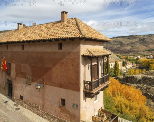 Alberque hostel building with flags flying, historic buildings in medieval village of Albarracín, Teruel province, Aragon, Spain