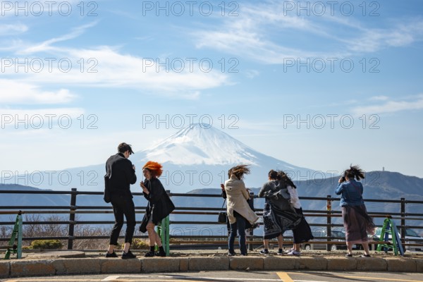 Tourists enjoy the view and take pictures, view of the snow-covered summit of Mount Fuji volcano in spring, Owakudani, Hakone, Japan
