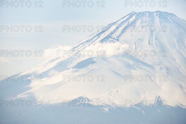Snow-covered summit of Mount Fuji volcano in spring, Owakudani, Hakone, Japan