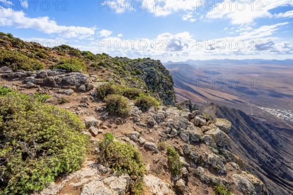 Castillejo viewpoint, view from the Risco de Famara cliffs to the coast and the sea with the Famara beach, Playa de Famara, Lanzarote, Canary Islands, Spain