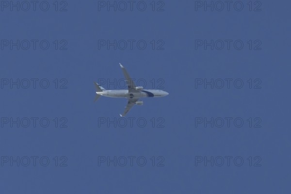 Boeing 737 jet passenger aircraft of El Al Israel airlines flying in a blue sky, England, United Kingdom