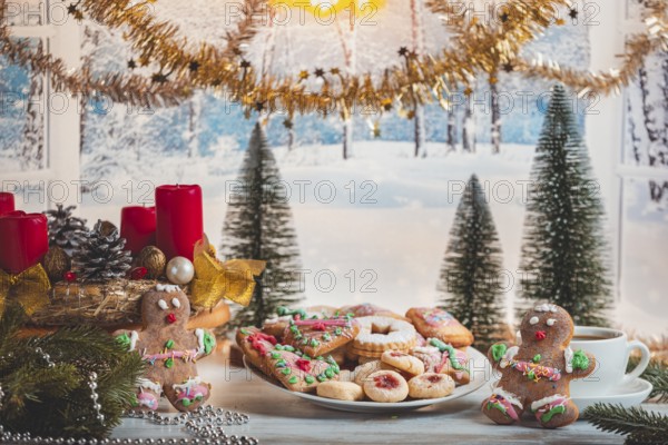 Christmas table with cookies and decorations in front of snow-white landscape