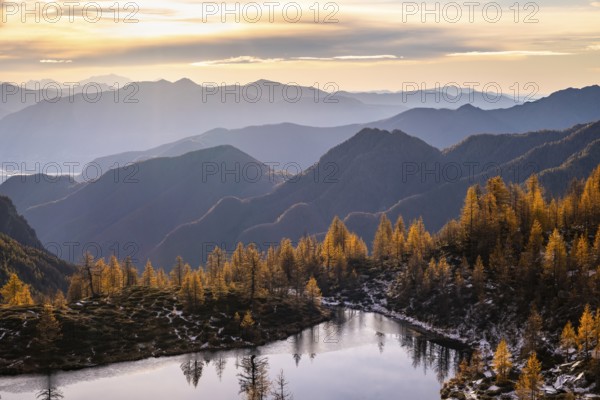 Laghetto dei Saléi mountain lake with autumnal larches (Larix), Onsernone Valley, Canton of Tessin, Switzerland