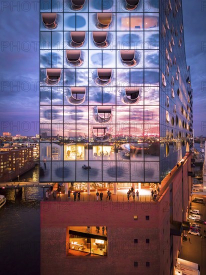 Aerial view of the Elbe Philharmonic Hall with reflections on the façade in the evening light above the harbor, Hamburg, Germany