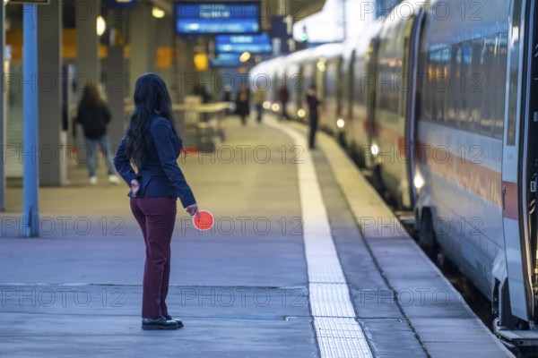 ICE train ready for departure, train staff waiting for the signal to continue, at Essen main station, on the platform, North Rhine-Westphalia, Germany