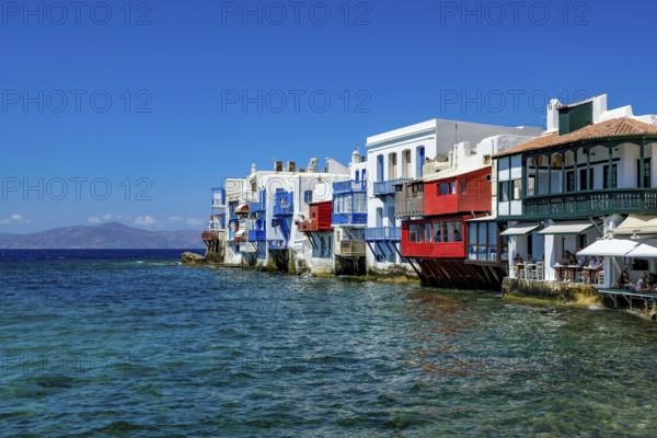 Mykonos, Cyclades, Greece - Little Venice is a picturesque neighborhood in Mykonos Town with colorful houses that stand right by the sea and are reminiscent of Venice. Little Venice is located on Alefkandra Bay next to the famous windmills of Mykonos. Mykonos is part of the Cyclades archipelago in the Aegean Sea