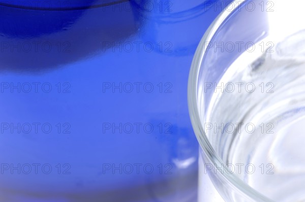 Glass with mineral water, small carbonated pearls on the edge of the glass, drinking water