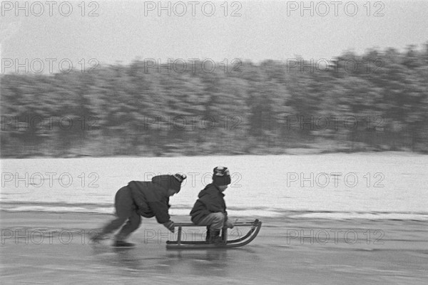Children ride sledges on ice rink, Bleckede, Lower Saxony, Germany, January 04, 1995, vintage, retro, old, historic