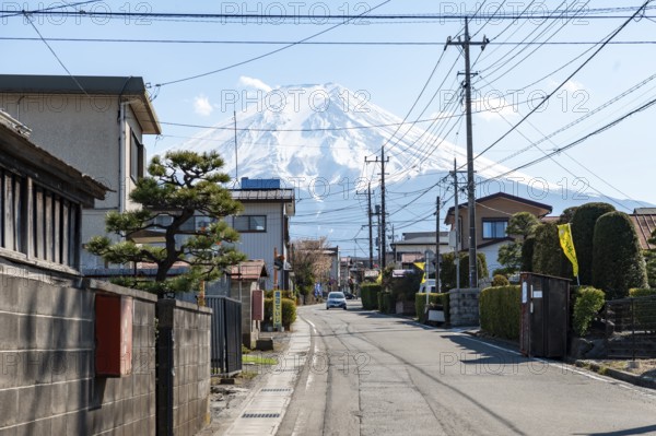 Street scene in a residential area, residential buildings and power lines, view of Mt. Fuji, Fujiyoshida, Yamanashi Prefecture, Japan