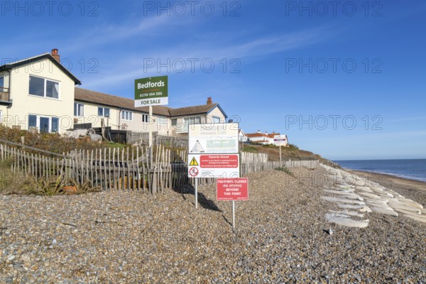 For Sale estate agent signs outside houses at risk of coastal erosion, Thorpeness, Suffolk, North Sea coast, England, UK October 2025