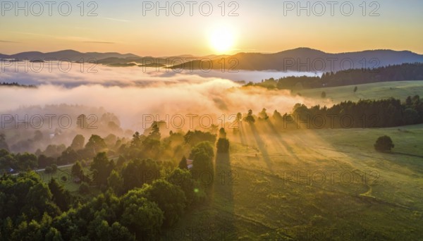 Sunrise over a fog covered village in a rural landscape, golden morning light, serene autumn atmosphere, hills and mountains in the background, AI generated