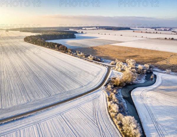 Bird Eye Perspective of Frost Covered Farmland. Seasonal Agricultural Scenery, winter and autumn scene, blue sky with golden light at sunrise, AI generated