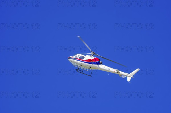 An Aerospatiale AS-350 BA Ecureuil helicopter, registration D-HAAN, from Meravo Air Company during a flight demonstration as part of an air show on Rossfeld in Metzingen-Glems, Baden-Württemberg, Germany, for editorial use only