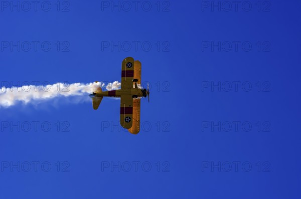 A Boeing PT-17 Stearman biplane, also Boeing Stearman Model 75, with the inscription 399 USNAVY N67193 during a flight demonstration as part of an air show on Rossfeld in Metzingen-Glems, Baden-Württemberg, Germany, for editorial use only