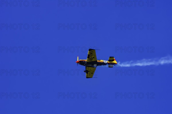 A Votec 351 sport aircraft from the Swiss MSW Aviation AG with registration HB-YMV during a flight demonstration as part of an air show on Rossfeld in Metzingen-Glems, Baden-Württemberg, Germany, for editorial use only