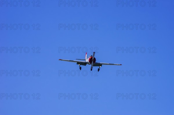 A Jakovlev Jak-52 with registration LY-HLZ during a flight demonstration as part of an air show on Rossfeld in Metzingen-Glems, Baden-Württemberg, Germany, for editorial use only