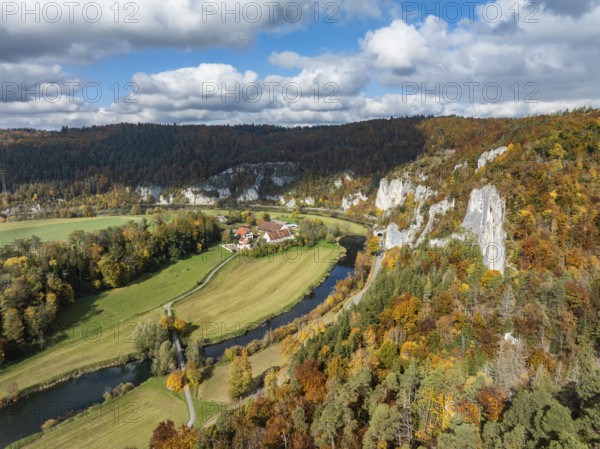 Aerial view of Käppeler Manor with St. George's Basilica near Thiergarten in the Upper Danube Valley, surrounded by autumn vegetation, on the right the raven rocks, climbing rocks, Jura limestone rocks, Sigmaringen district, Baden-Württemberg, Germany