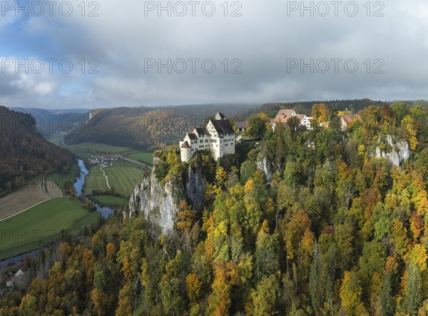 Aerial view of Werenwag Castle and former Werenwag Castle on a rocky spur in the Upper Danube Valley, surrounded by autumnal vegetation and clouds of fog, Sigmaringen district, Baden-Württemberg, Germany