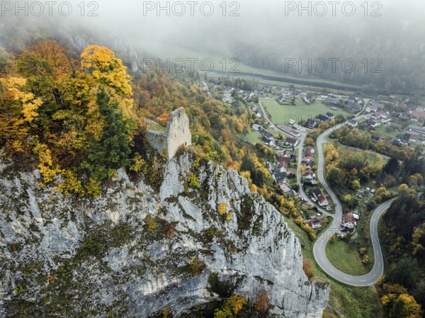 Aerial view of the viewpoint, shovels and Hausen Castle, also known as the Hausen ruins, surrounded by autumnal vegetation and clouds of fog, a ruin of a castle above the village of Hausen in the valley in the Upper Danube Valley, Beuron, Sigmaringen district, Baden-Württemberg, Germany