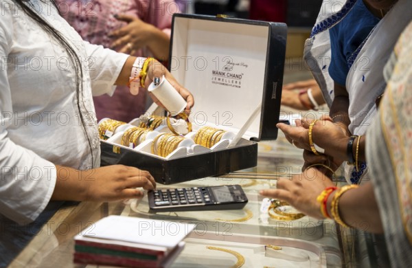 Customers purchase Gold jewelry at a store on the occasion of the festival of Dhanteras, in Guwahati, Assam, India on 18 October 2025. People rushing to buy gold even after its nearly 60% surge to record highs this year
