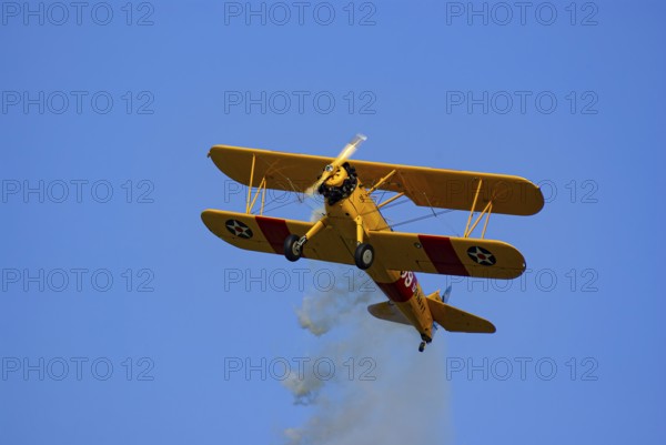 A Boeing-Stearman biplane during a flight demonstration as part of an air show at the Rossfeld in Metzingen-Glems, Baden-Württemberg, Germany, for editorial use only