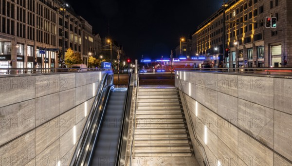 Night photo, long exposure with motion blur, modern underground entrance at Unter den Linden station, contemporary design with stairs and escalator, Berlin, Germany