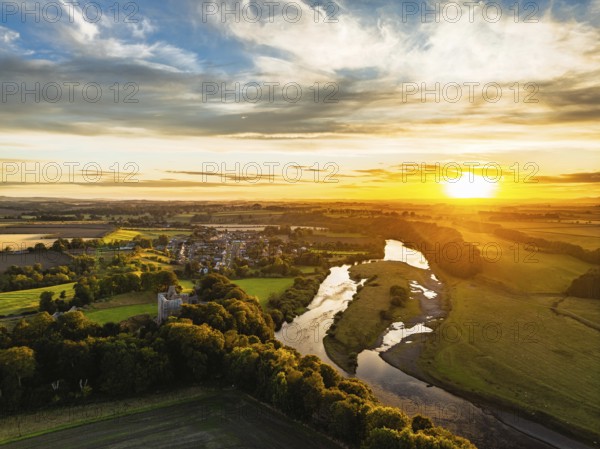 Sunset over Norham Castle and River Tweed from a drone, Norham, Northumberland, England, United Kingdom