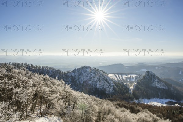 View over the hills and valleys from the mountain with hoarfrost on the branches in winter, Vápec, Horná Poruba, Slovakia