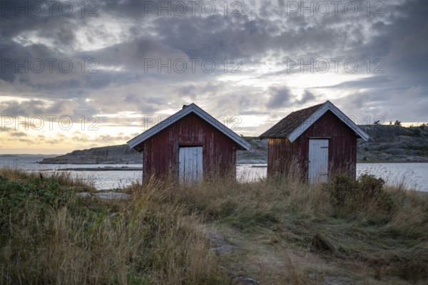 Falun red or Swedish red boathouses by the sea, Resö Island, Bohuslän, Skagerrak, Sotenäs, Västra Götalands län, Sweden