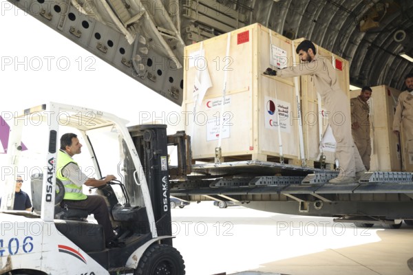 Members of the Qatari Air Force unload humanitarian aid supplies from a transport aircraft at Damascus International Airport as part of Qatar's air and land relief bridge to Syria, Damascus, Damascus, Syria