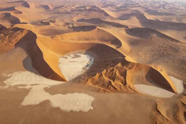 Sand dunes and dry pans in the Namib Desert. In the evening. Aerial view. Namib-Naukluft Park, Namibia