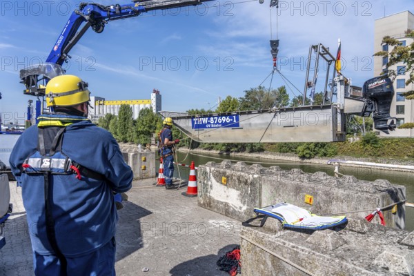 Launching, with crane, of a THW multi-purpose boat in front of a training trip on the Rhine, near Düsseldorf, of the Water Hazards Section, this type of boat is used to transport people and goods as a rescue boat and as a working platform, during the major exercise FÜLEX25, lasting several days, of the THW, Technical Relief Organisation, North Rhine-Westphalia Regional Association, over 3500 volunteers from the 127 North Rhine-Westphalia local associations practise many different deployment scenarios over 4 weekends