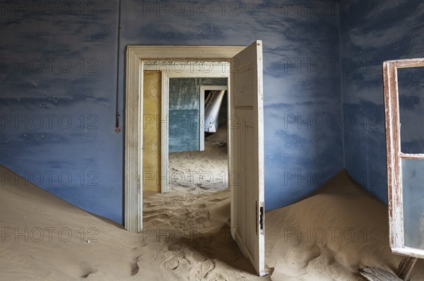 At Kolmanskop, the abandoned ghost town of the diamond days of the early 1900 and of German origin. Inside the restricted Diamond Area east of the coastal town of Lüderitz. Namib Desert, Namibia