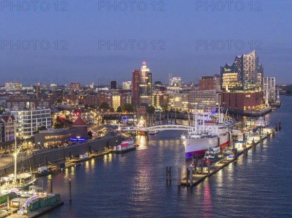 Aerial view of the Landungsbrücken Hamburg (Jan-Fedder-Promenade) at blue hour with Elbe, Cap San Diego and Elbphilharmonie in the background, Hamburg, Germany