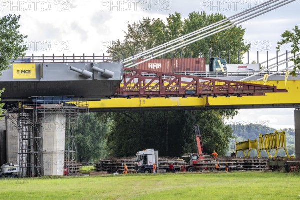 New construction of the second motorway bridge Neuenkamp of the A40, over the Rhine near Duisburg, parallel to the already existing first bridge, most of the new bridge piers are in place, two first bridge segments are finished and have already been moved towards the river on both sides of the Rhine, full completion is planned for 2028, North Rhine-Westphalia, Germany
