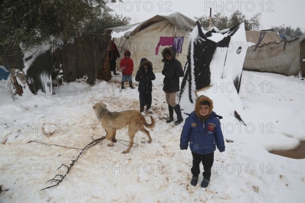 Displaced Syrian families and children living in refugee camps during harsh winter conditions, facing snow, cold weather, and difficult humanitarian circumstances. Aleppo, Syria January 01, 2022, Aleppo, Syria